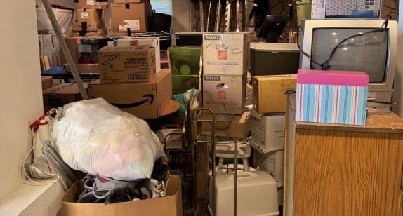 Moving boxes and packed items in a storage or office space.