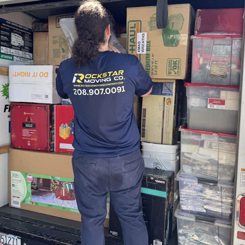 Employee packing boxes for moving services at Rockstar Moving Company.