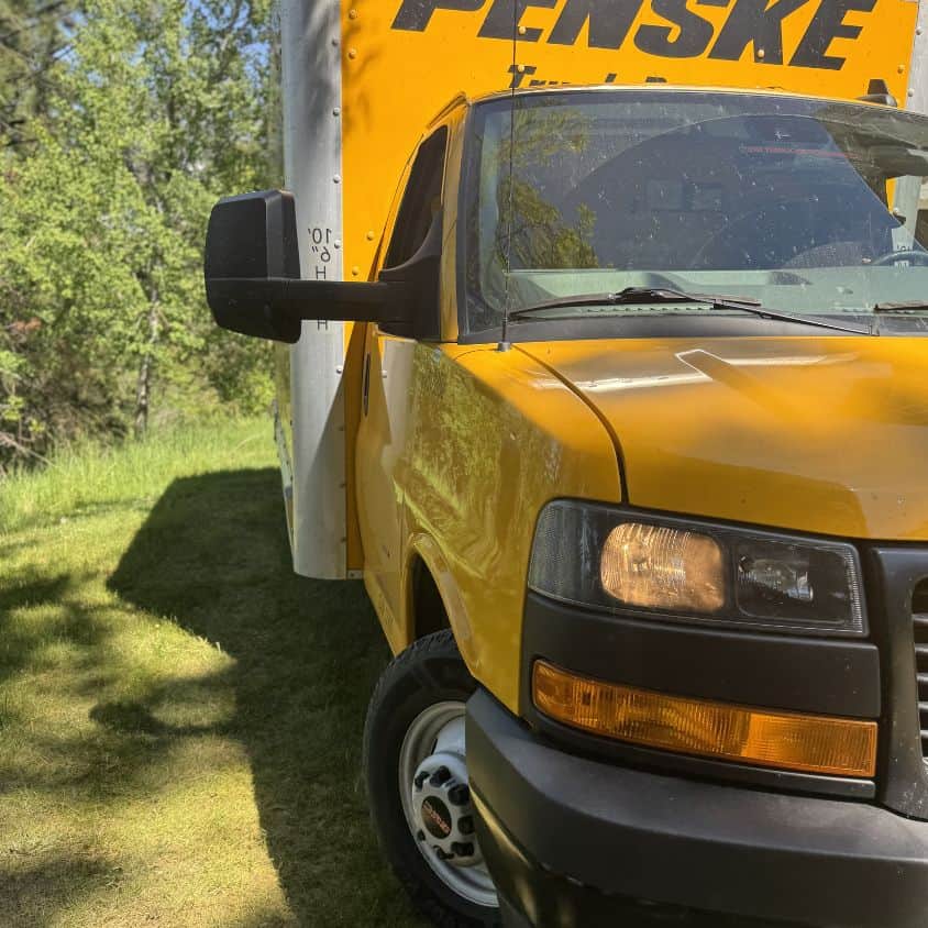 Yellow Penske moving truck parked outdoors for local service areas.