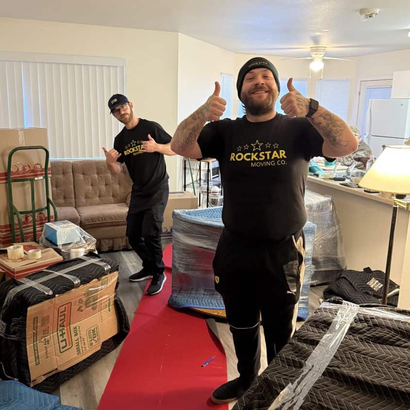 Movers from Rockstar Moving Company packing furniture inside a home.